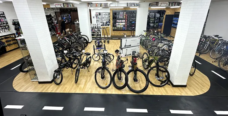 Bicicletas de segunda mano sobre una isla de madera rodeada por el carril bici de la tienda
